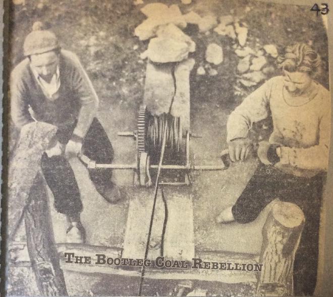 A man and woman hand-crank a windlass at a bootleg coal mine.